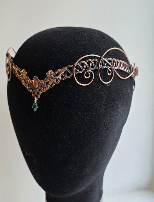 Antique oxidized copper elven circlet with an emerald green crystal teardrop, featuring a V-shape forehead point and intricate wire-woven design.