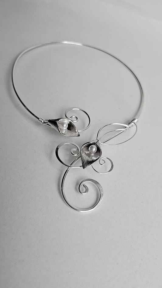 Handcrafted silver-plated Calla Lily torc necklace with two faux pearl centers, featuring elegant hammered wire curls and an open-back collar design.