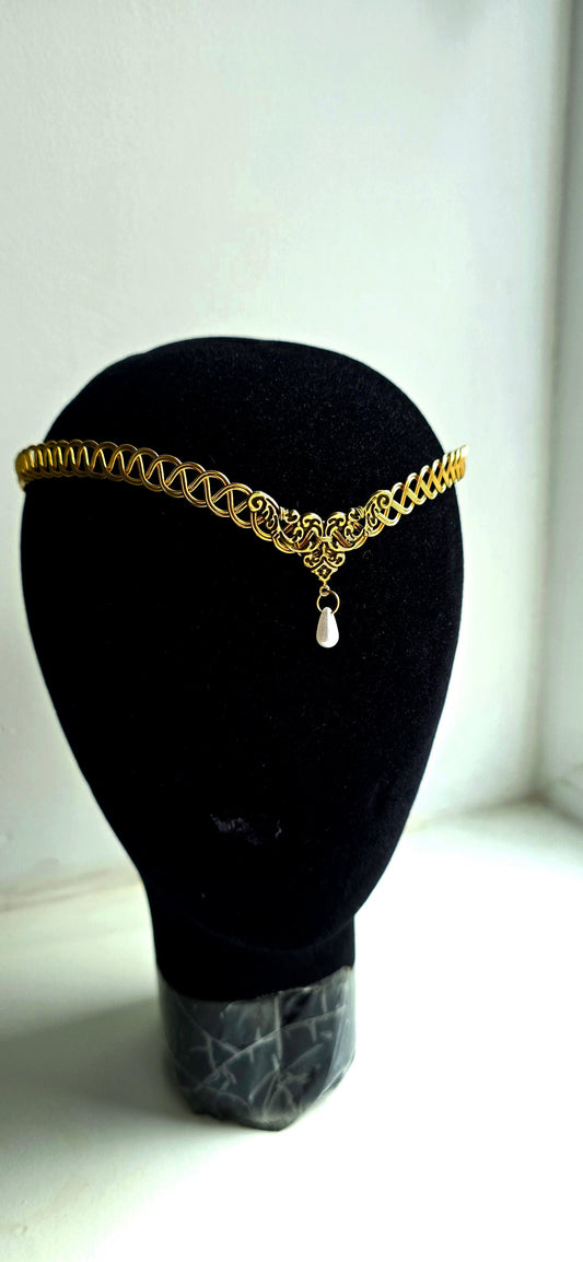 Handcrafted brass Celtic weave circlet featuring a delicate faux pearl teardrop pendant, displayed on a black mannequin head.