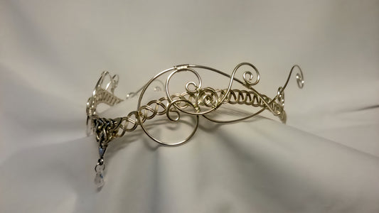 Handcrafted silver-plated Celtic tiara for handfasting, featuring a triquetra knot and iridescent AB crystal on a soft white background.